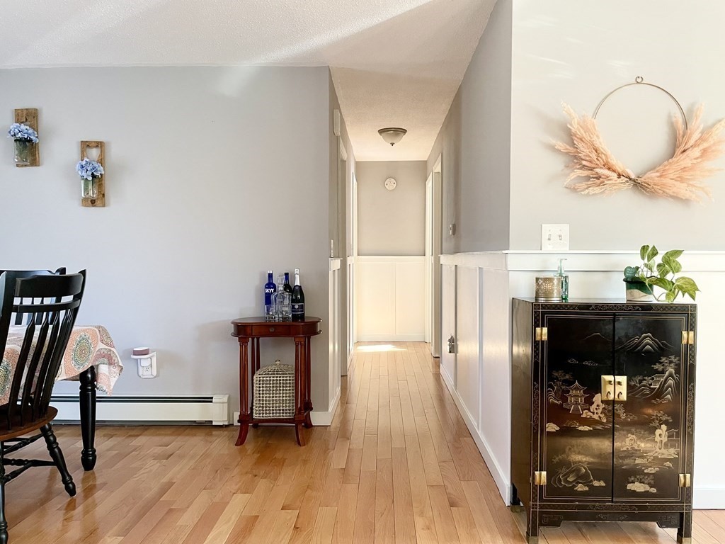 4 Vine Street Webster, MA 01570 - Photo 11 of 19 a view of a hallway with wooden floor and furniture