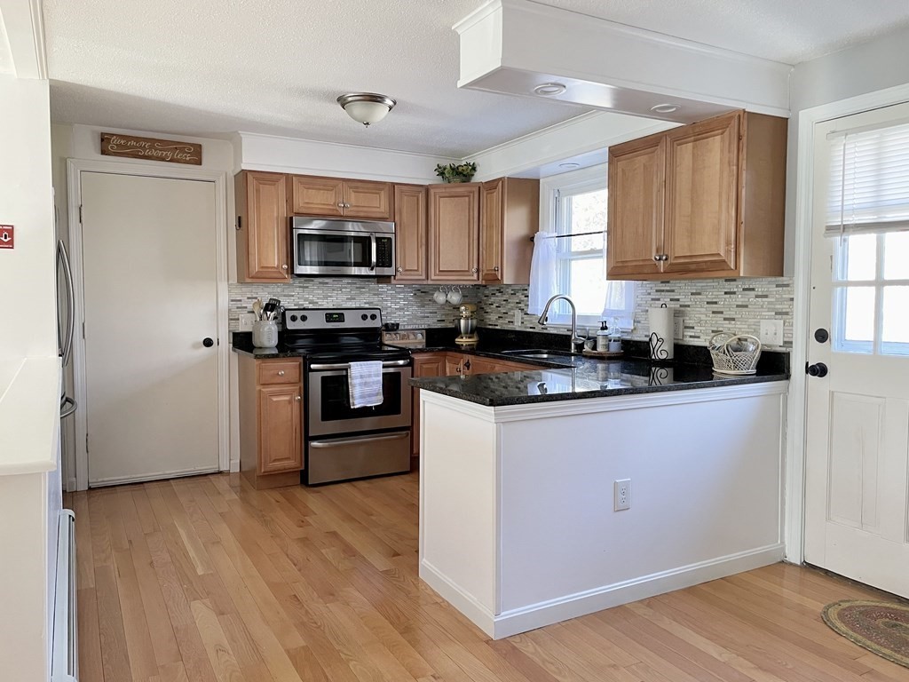 4 Vine Street Webster, MA 01570 - Photo 4 of 19 a kitchen with stainless steel appliances granite countertop a stove a sink and a microwave