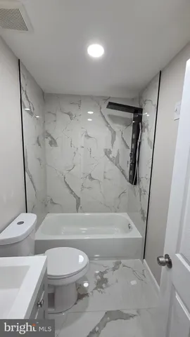 a bathroom with a bathtub and shower