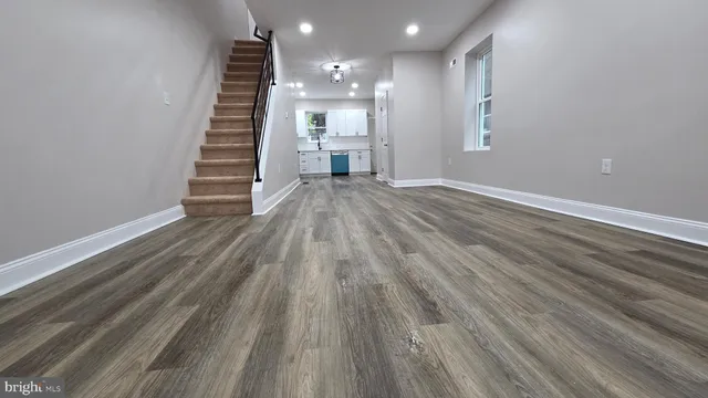 a view of a room with wooden floor and stairs