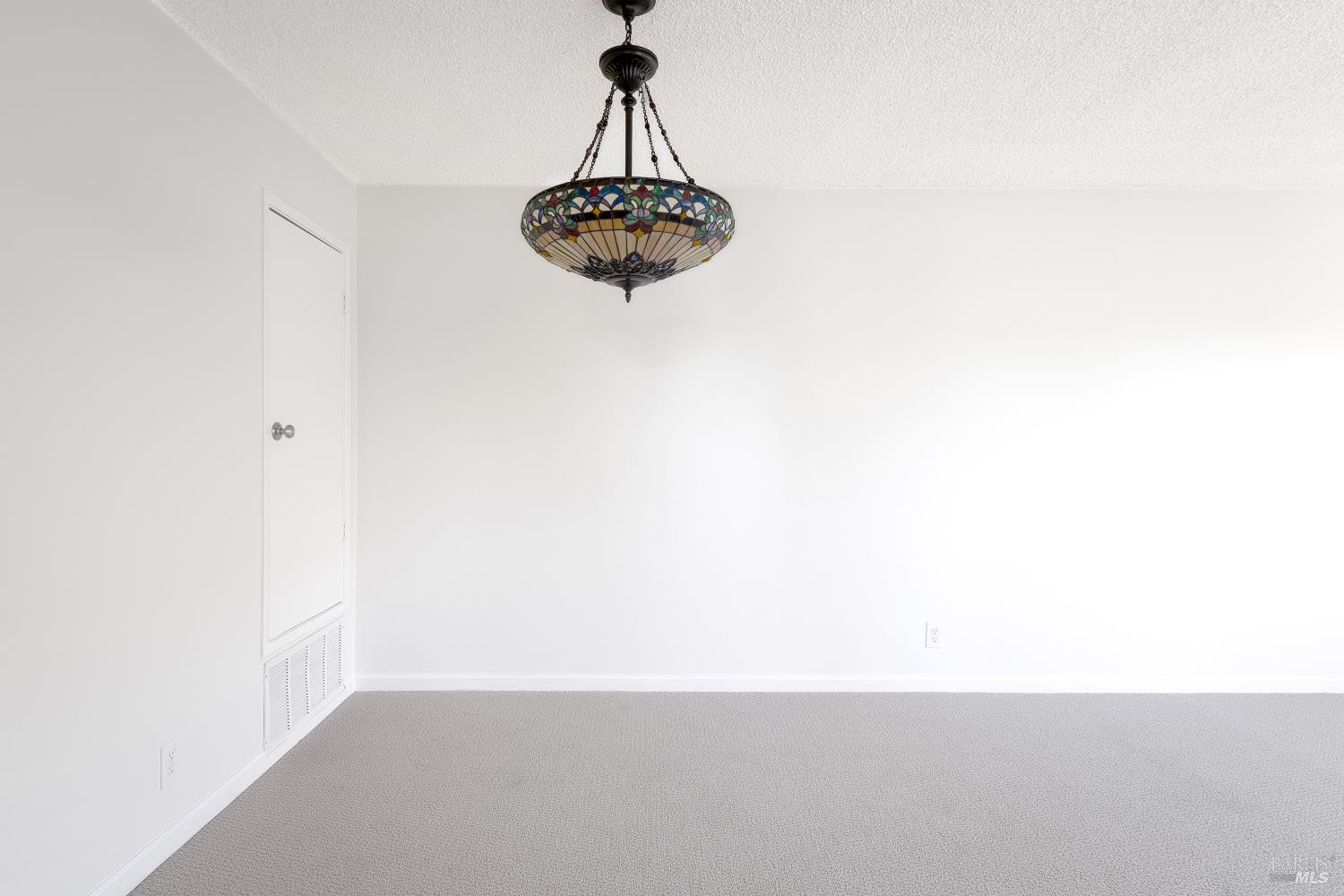 247 Bahia Place San Rafael, CA 94901 - Photo 8 of 22 a picture of a wall with a chandelier fan