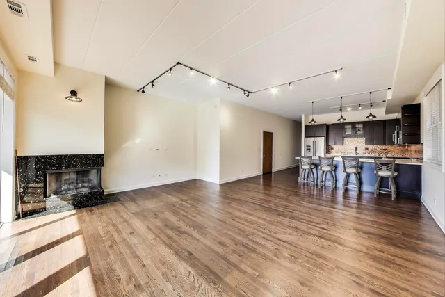 a kitchen with stainless steel appliances a refrigerator and a stove top oven