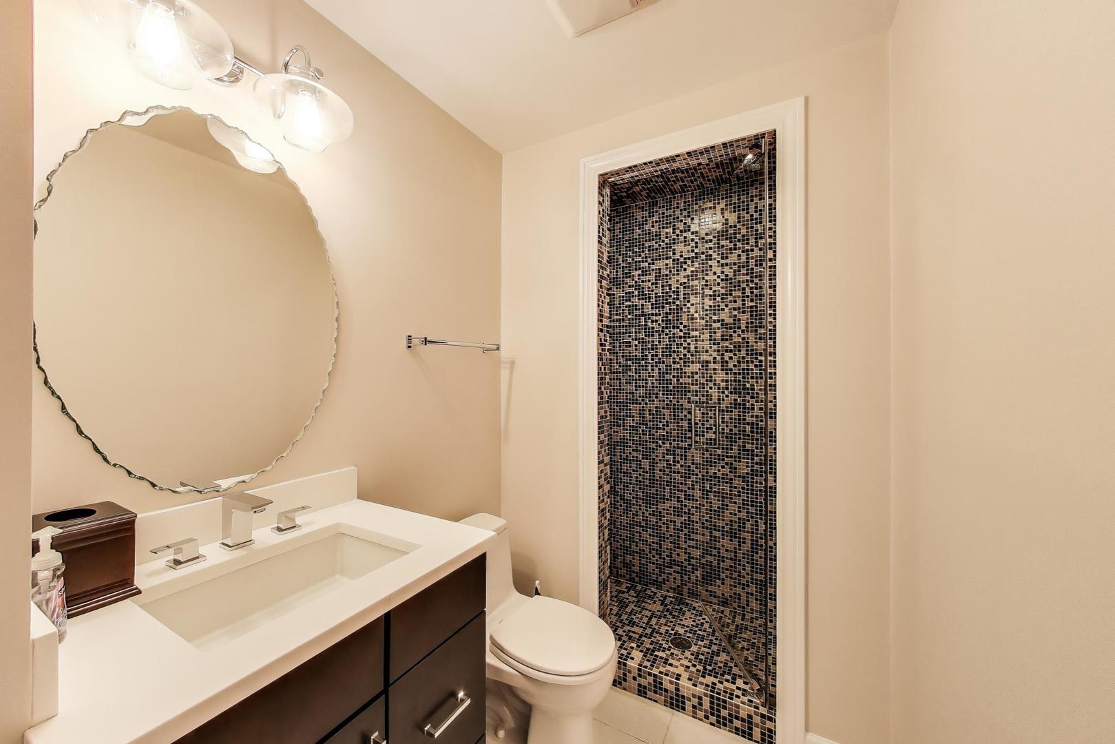 1332 West Madison Street, Unit 4E Chicago, IL 60607 - Photo 7 of 12 a bathroom with a sink a toilet and a mirror