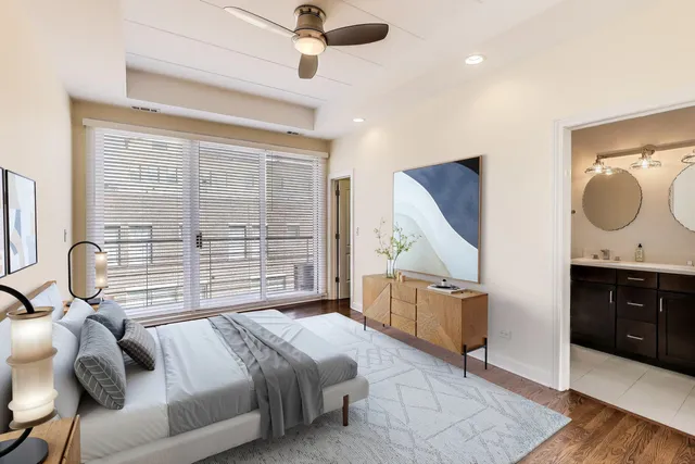 a bedroom with a bed dresser and a wooden floor