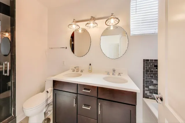 a bathroom with a toilet sink and mirror