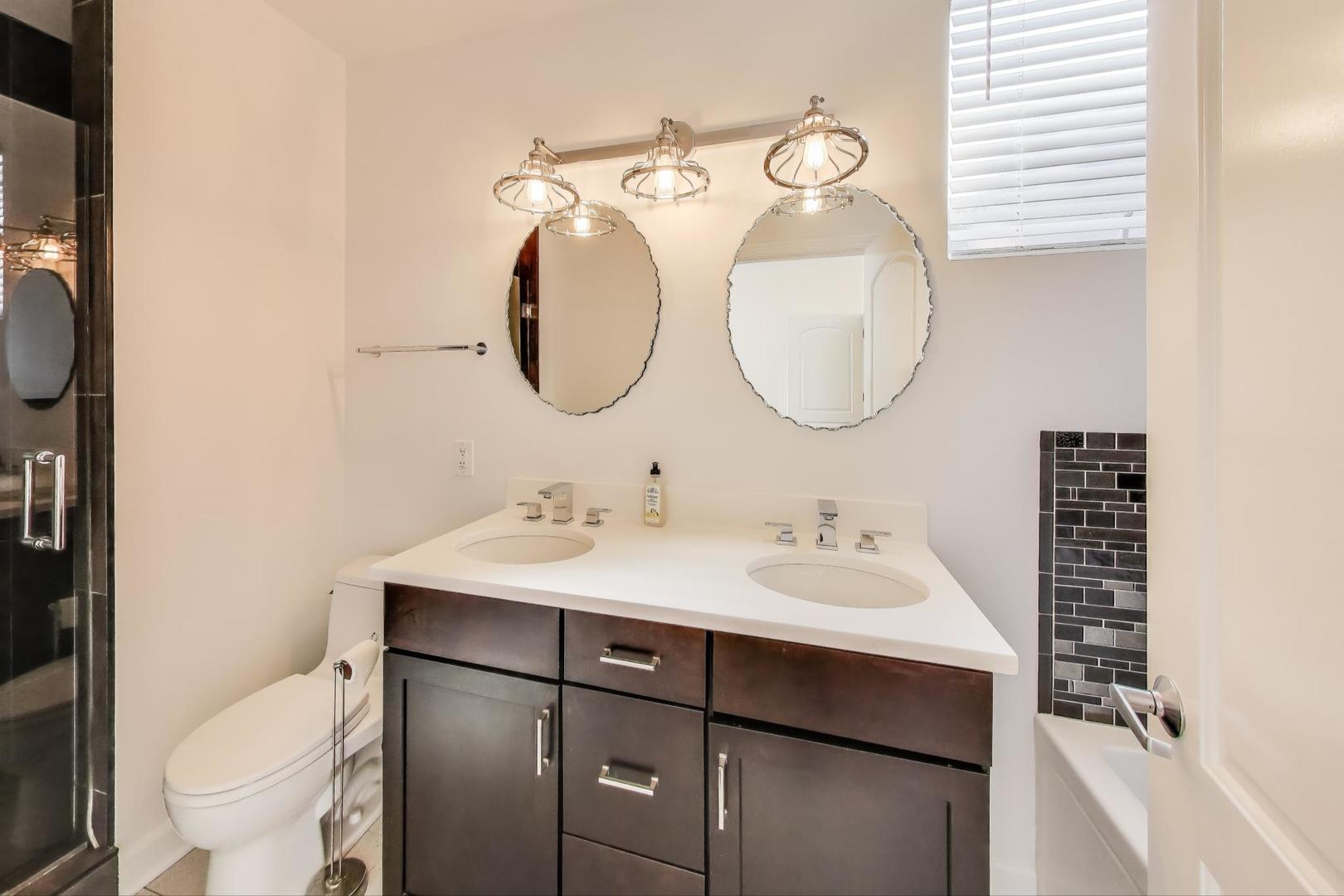 1332 West Madison Street, Unit 4E Chicago, IL 60607 - Photo 10 of 12 a bathroom with a toilet sink and mirror