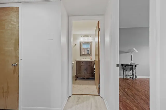 a view of a hallway and wooden floor a living room