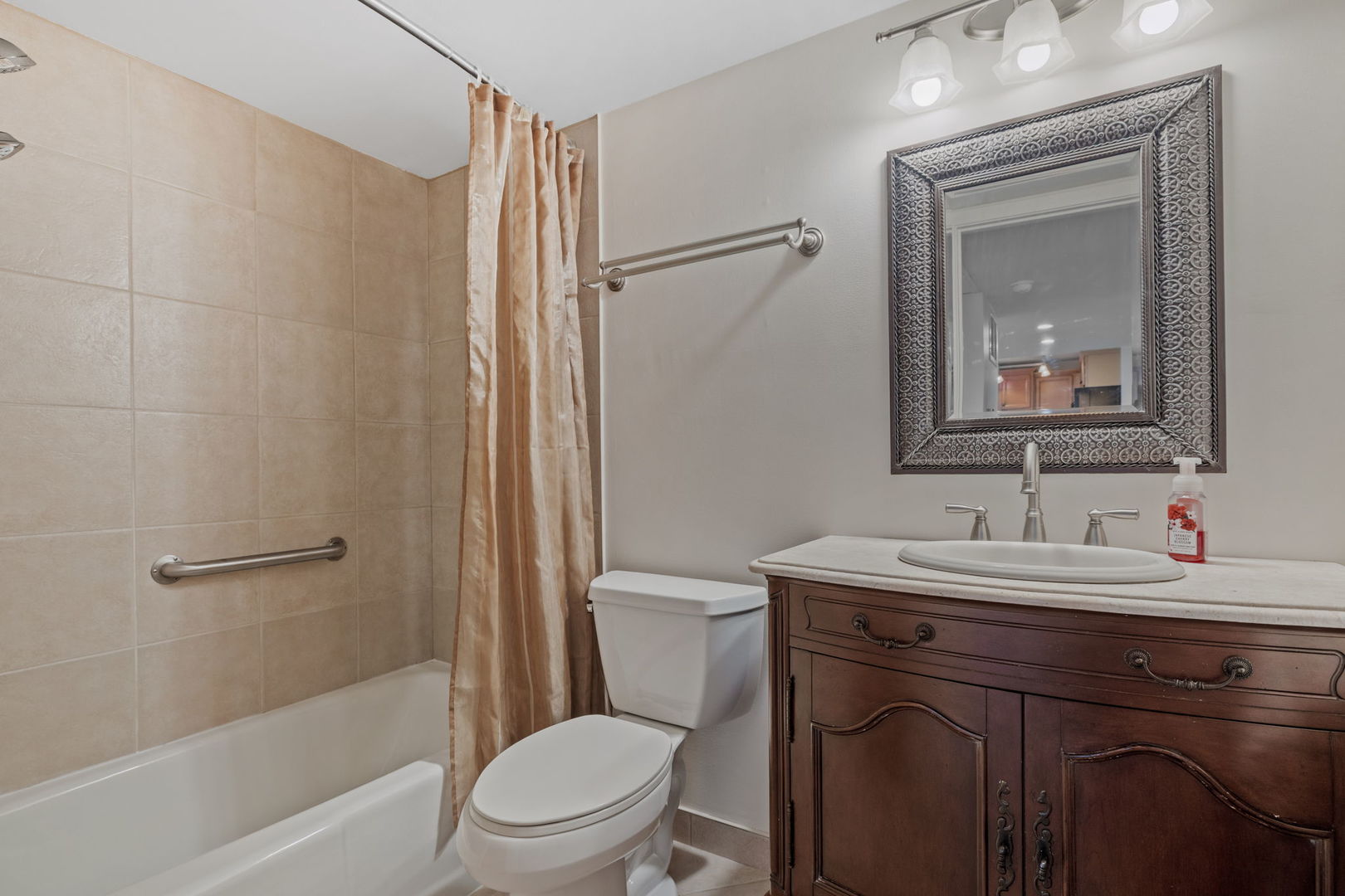 5540 Walnut Avenue, Unit 6B Downers Grove, IL 60515 - Photo 12 of 25 a bathroom with a toilet a sink a mirror a vanity and shower