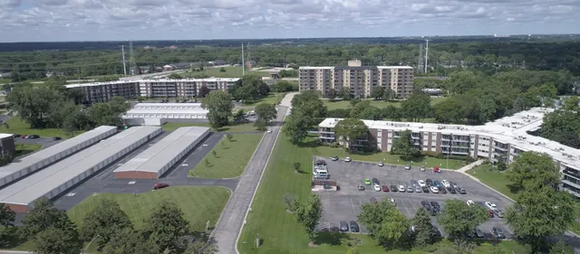 an aerial view of a house with a garden and lake view
