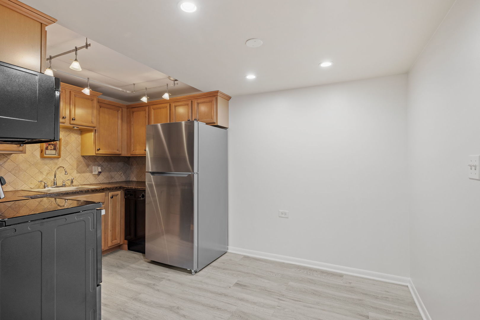 5540 Walnut Avenue, Unit 6B Downers Grove, IL 60515 - Photo 6 of 25 a kitchen with stainless steel appliances granite countertop a refrigerator and a stove top oven