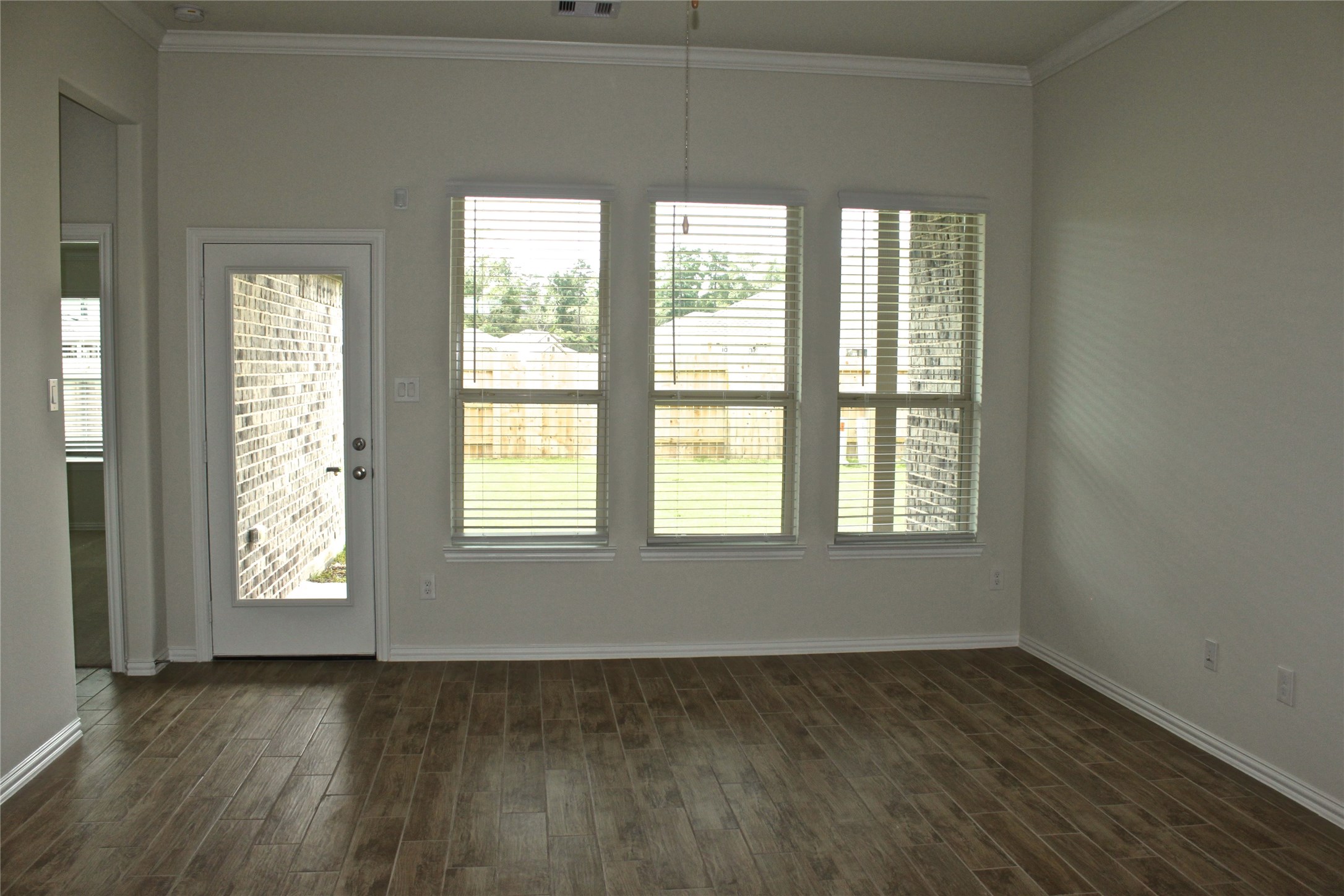 4408 Mimic Drive Spring, TX 77386 - Photo 6 of 27 an empty room with wooden floor and windows