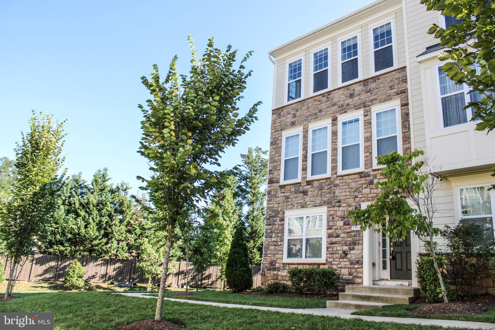 a front view of a building with trees