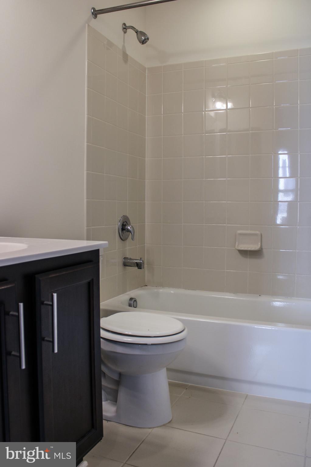 9914 Wood Edge Way Lanham, MD 20706 - Photo 11 of 67 a bathroom with a sink a toilet and shower