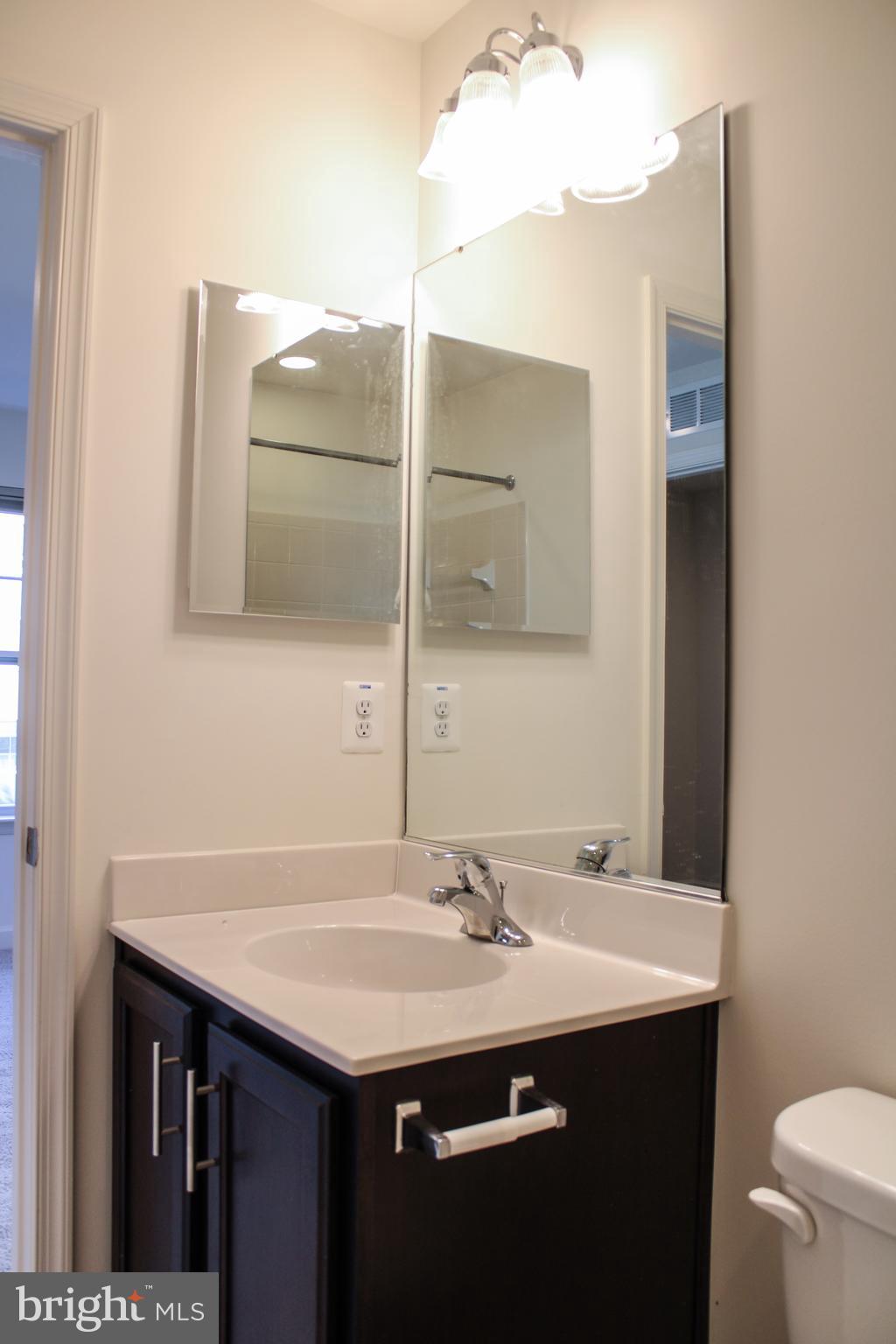 9914 Wood Edge Way Lanham, MD 20706 - Photo 12 of 67 a bathroom with a sink and a mirror