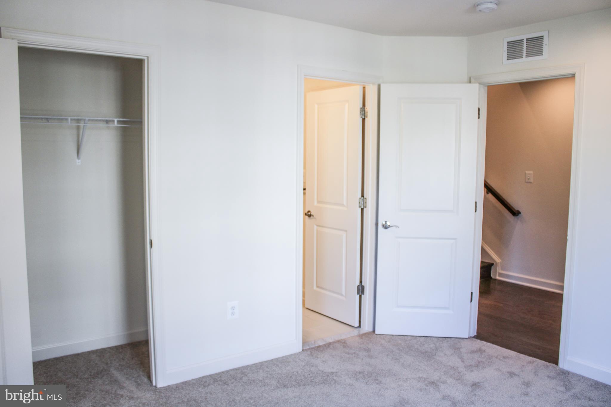 9914 Wood Edge Way Lanham, MD 20706 - Photo 15 of 67 a view of a hallway with closet and a bathroom