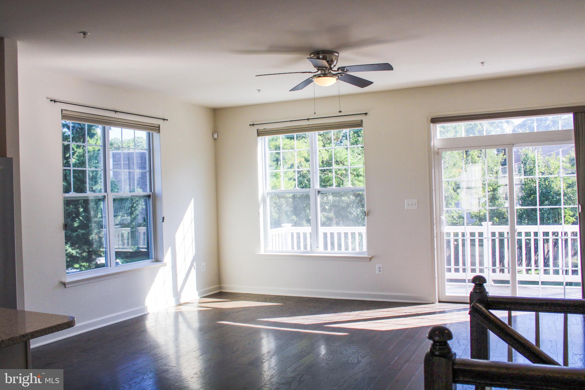 9914 Wood Edge Way Lanham, MD 20706 - Photo 21 of 67 a view of an empty room with wooden floor and a window