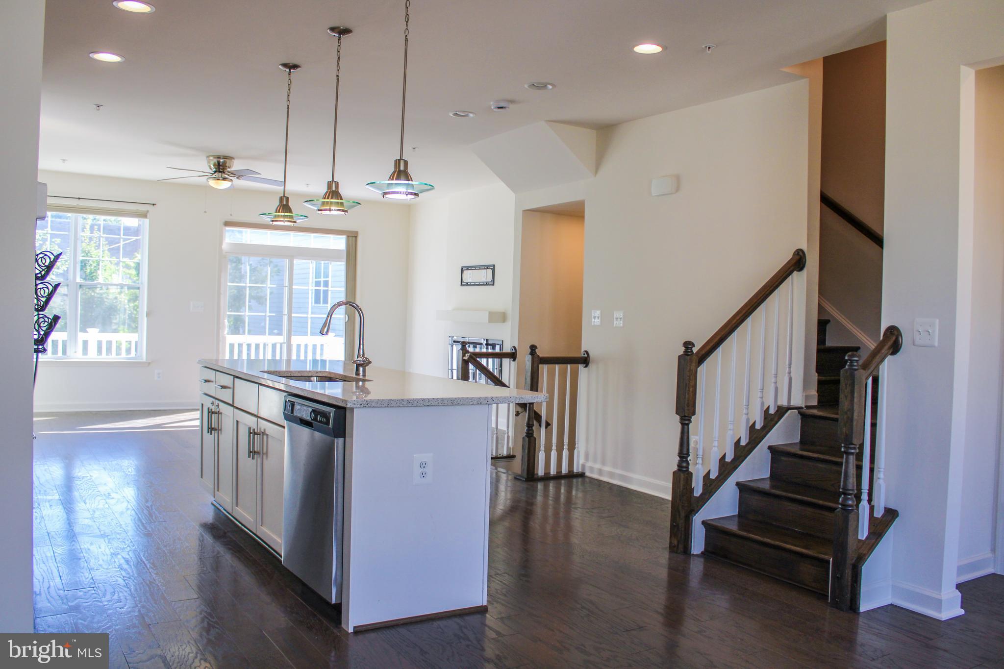 9914 Wood Edge Way Lanham, MD 20706 - Photo 26 of 67 a kitchen with granite countertop a stove a sink and a wooden floors