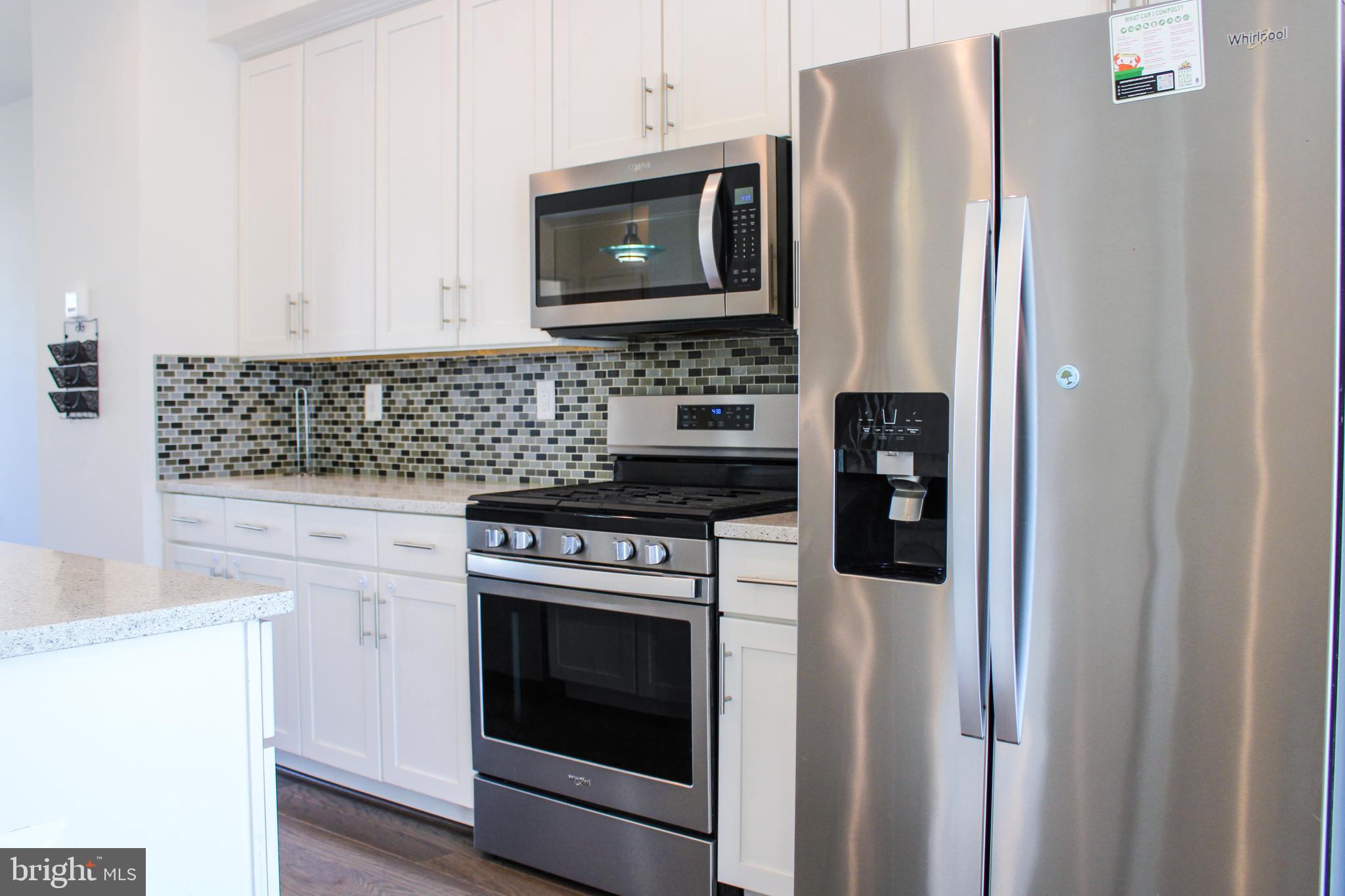 9914 Wood Edge Way Lanham, MD 20706 - Photo 29 of 67 a kitchen with stainless steel appliances granite countertop a refrigerator stove and microwave