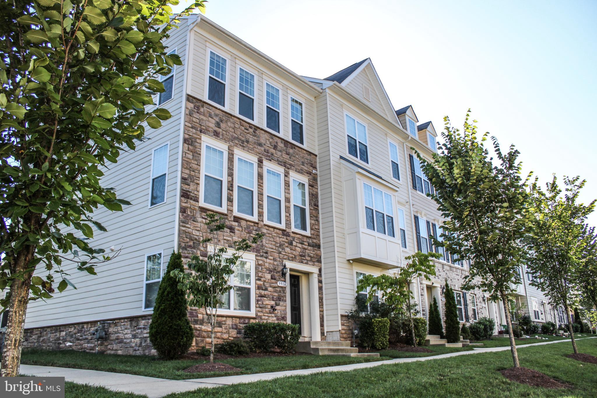 9914 Wood Edge Way Lanham, MD 20706 - Photo 3 of 67 a front view of a multi story building with yard