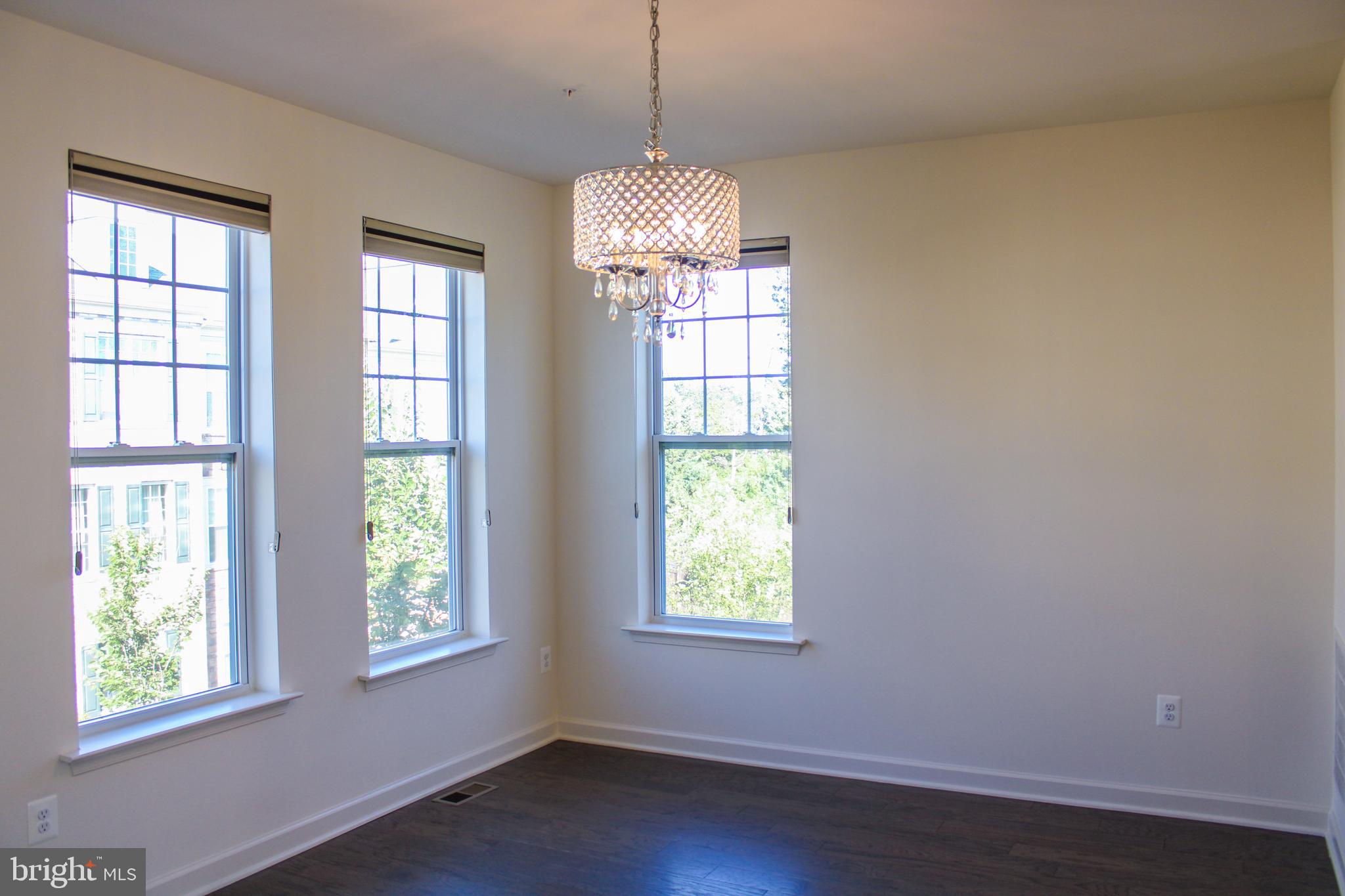 9914 Wood Edge Way Lanham, MD 20706 - Photo 32 of 67 a window in an empty room with wooden floor