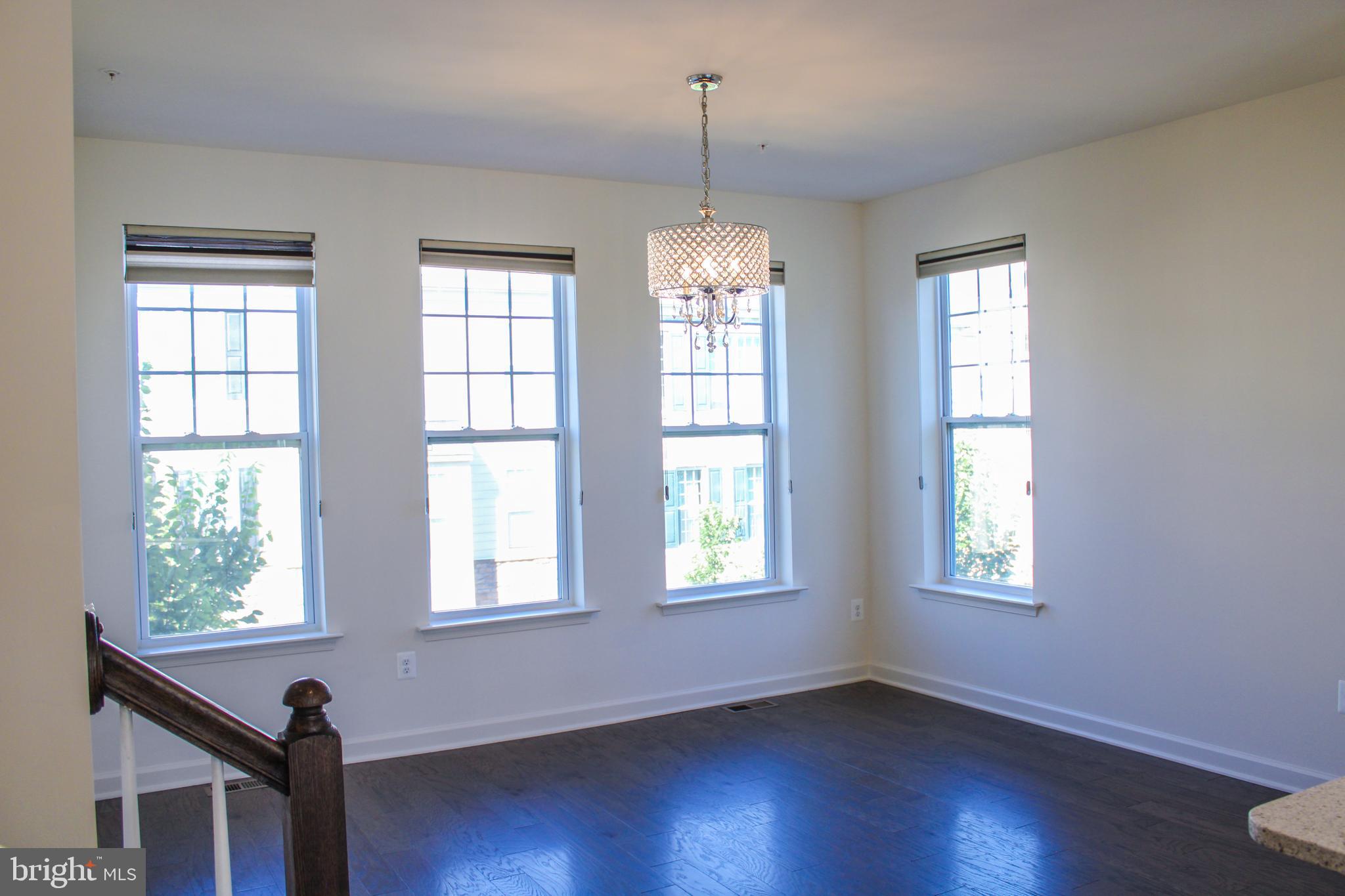 9914 Wood Edge Way Lanham, MD 20706 - Photo 34 of 67 a view of an empty room with wooden floor and a window