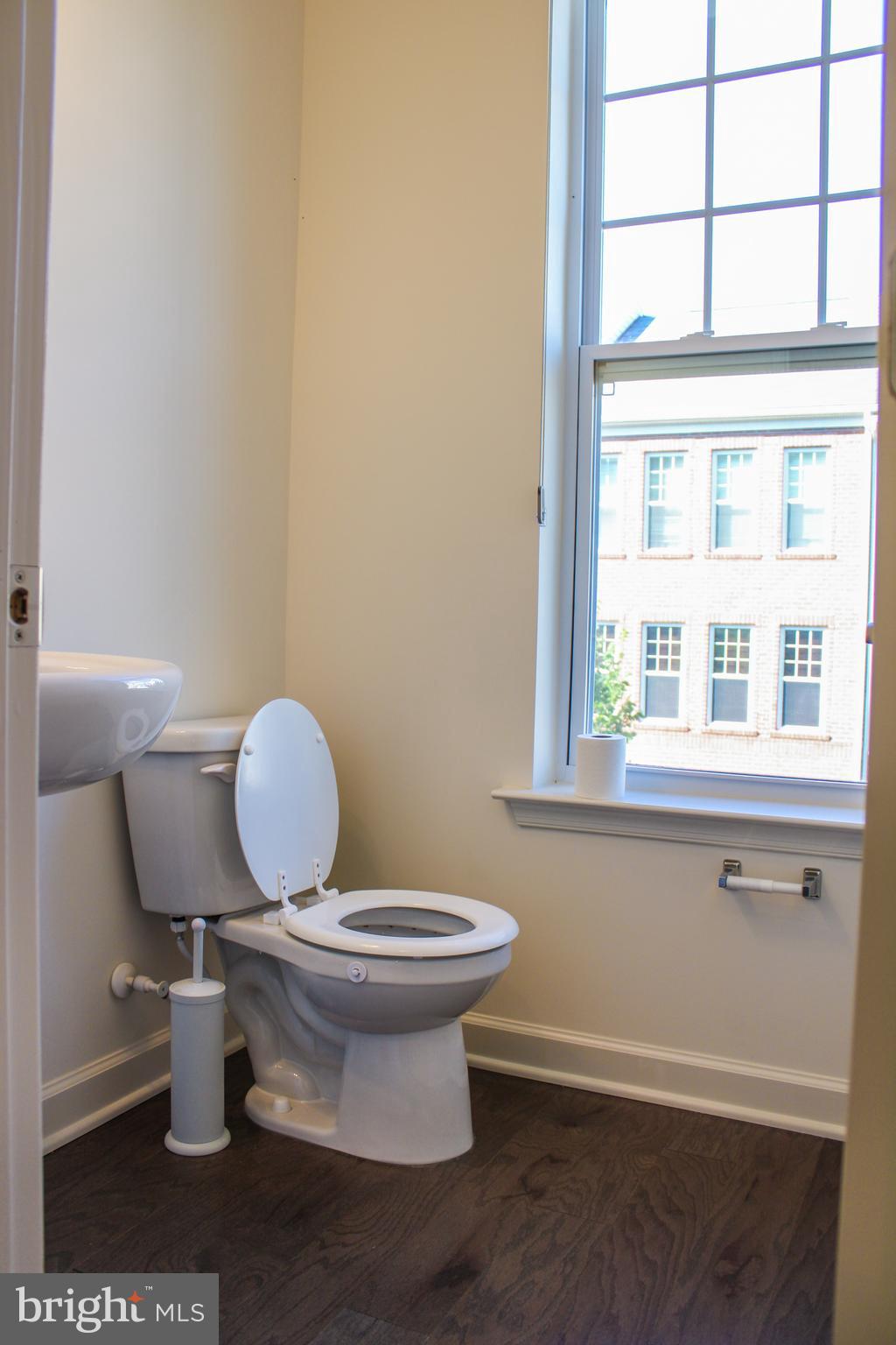 9914 Wood Edge Way Lanham, MD 20706 - Photo 35 of 67 a bathroom with a toilet a sink and a window