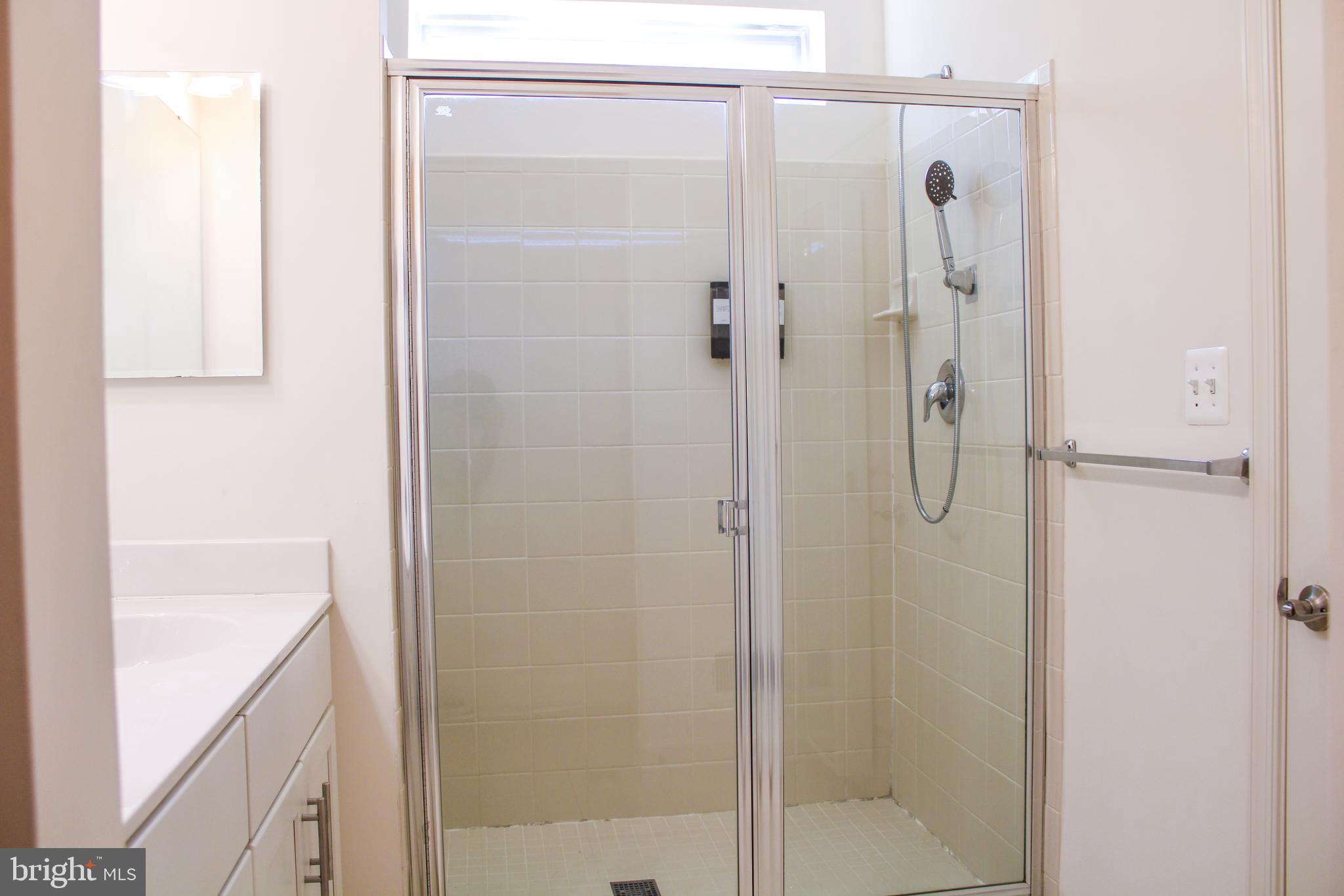 9914 Wood Edge Way Lanham, MD 20706 - Photo 45 of 67 a bathroom with a shower