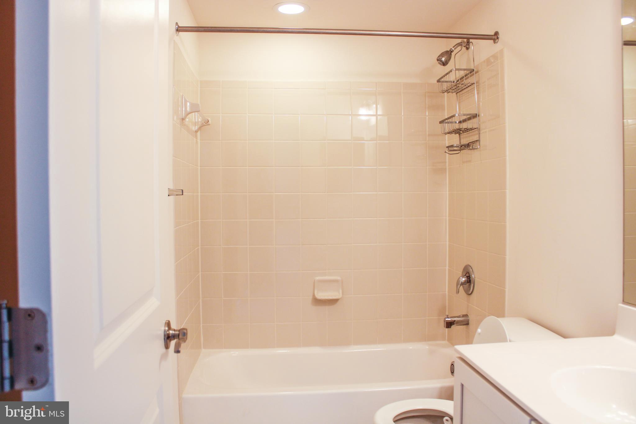 9914 Wood Edge Way Lanham, MD 20706 - Photo 47 of 67 a bathroom with a bathtub and a shower
