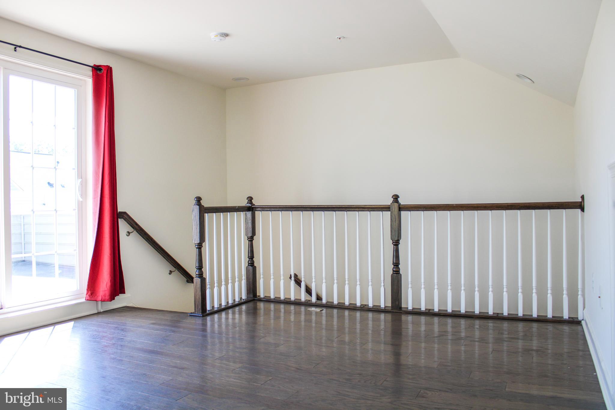 9914 Wood Edge Way Lanham, MD 20706 - Photo 62 of 67 a view of a hallway with wooden floor and windows
