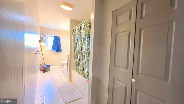 a view of a hallway with living room and furniture