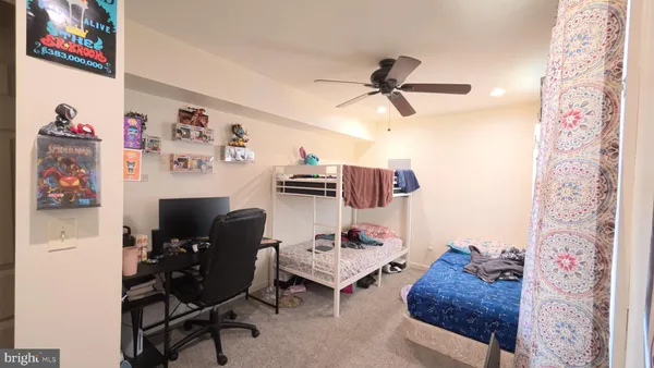 a bedroom with furniture and a mirror