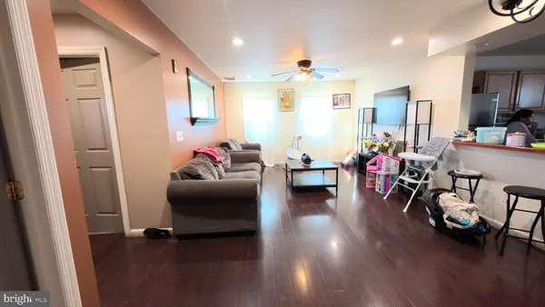 a kitchen with stainless steel appliances kitchen island granite countertop a sink cabinets and a refrigerator