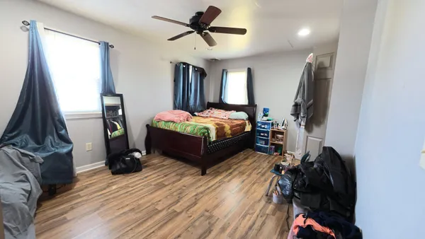 a bedroom with a bed closet and a window