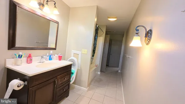 a bathroom with a sink vanity and a mirror