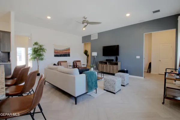 a living room with furniture and a potted plant