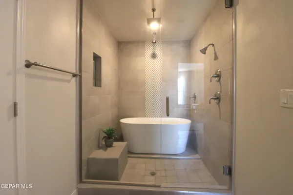 a bed room with a bed and a chandelier