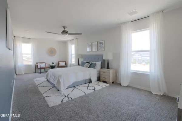 a bedroom with a bed and a lamp