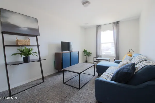 a bedroom with a bed wooden floor and lamp