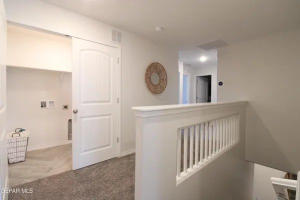 a view of a hallway a bathroom and a sink