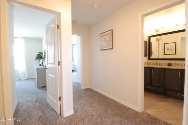a kitchen with kitchen island granite countertop a sink a counter top space and cabinets