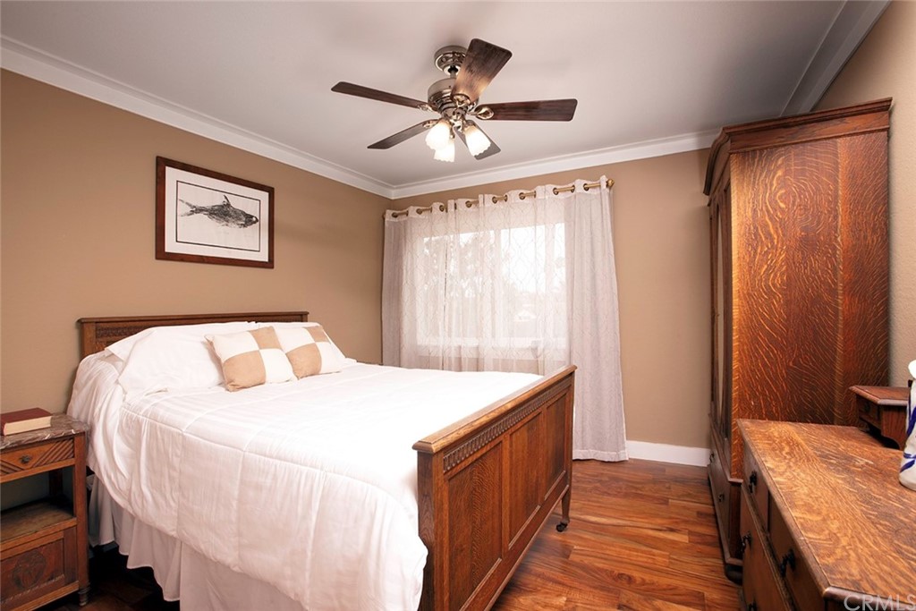 23965 Leeward Drive Dana Point, CA 92629 - Photo 14 of 27 a bedroom with a bed and a chandelier