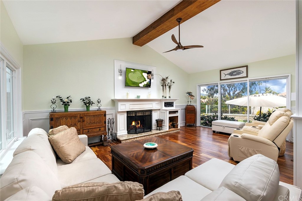23965 Leeward Drive Dana Point, CA 92629 - Photo 2 of 27 a living room with furniture a flat screen tv and a fireplace