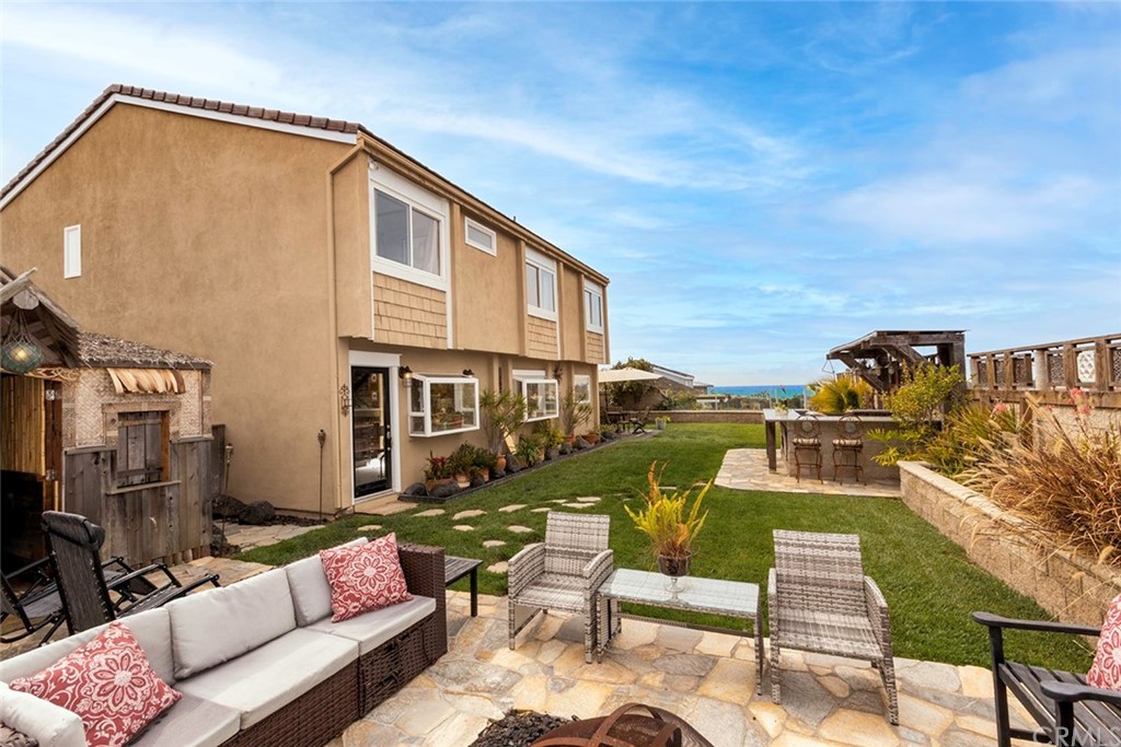23965 Leeward Drive Dana Point, CA 92629 - Photo 22 of 27 a view of a patio with couches chairs potted plants and a table