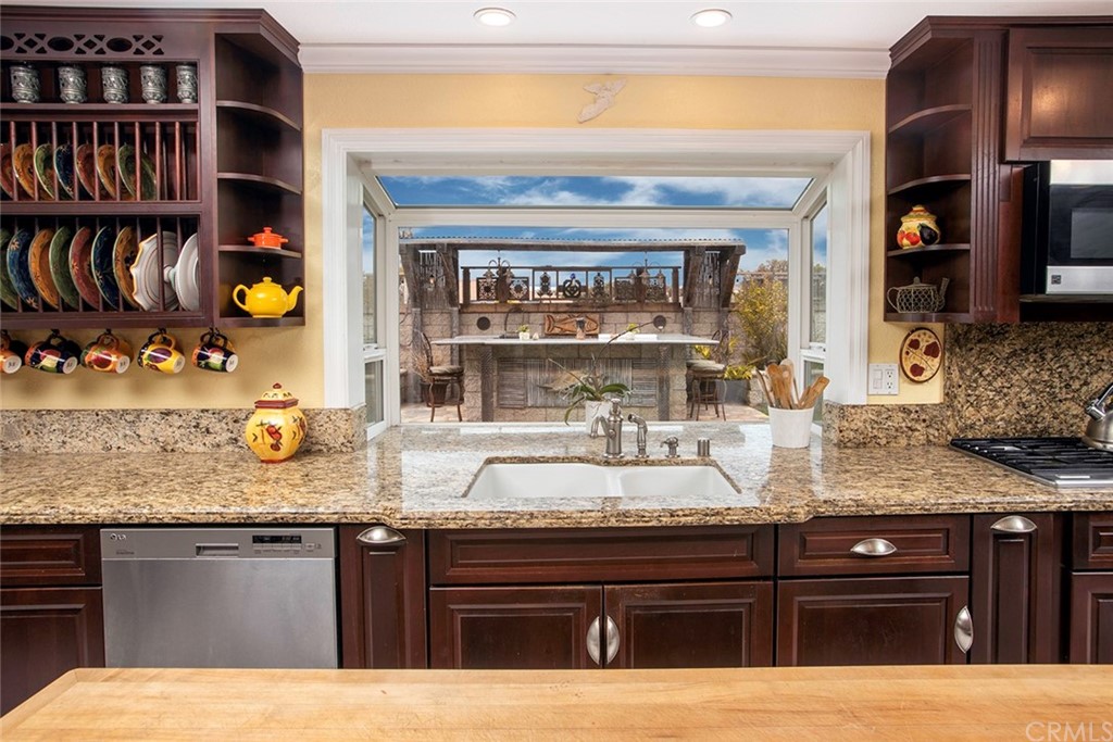 23965 Leeward Drive Dana Point, CA 92629 - Photo 6 of 27 a kitchen with stainless steel appliances granite countertop a stove and cabinets