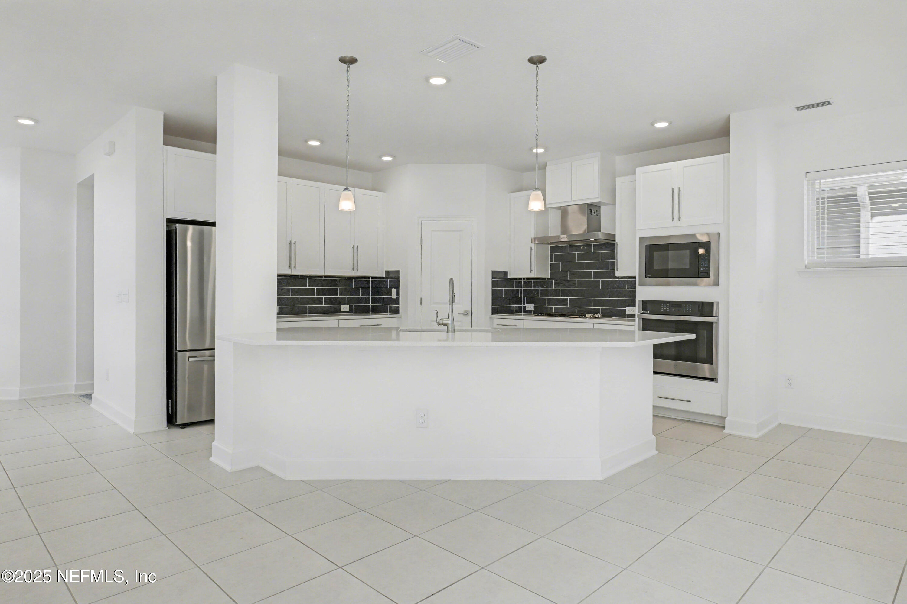 111 Windswept Way St. Augustine, FL 32092 - Photo 13 of 63 a large kitchen with kitchen island a stove a refrigerator a sink and a oven