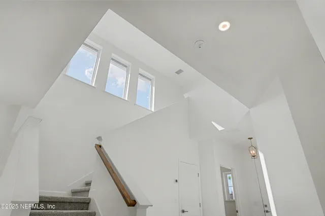 a bedroom with a bed and glass window
