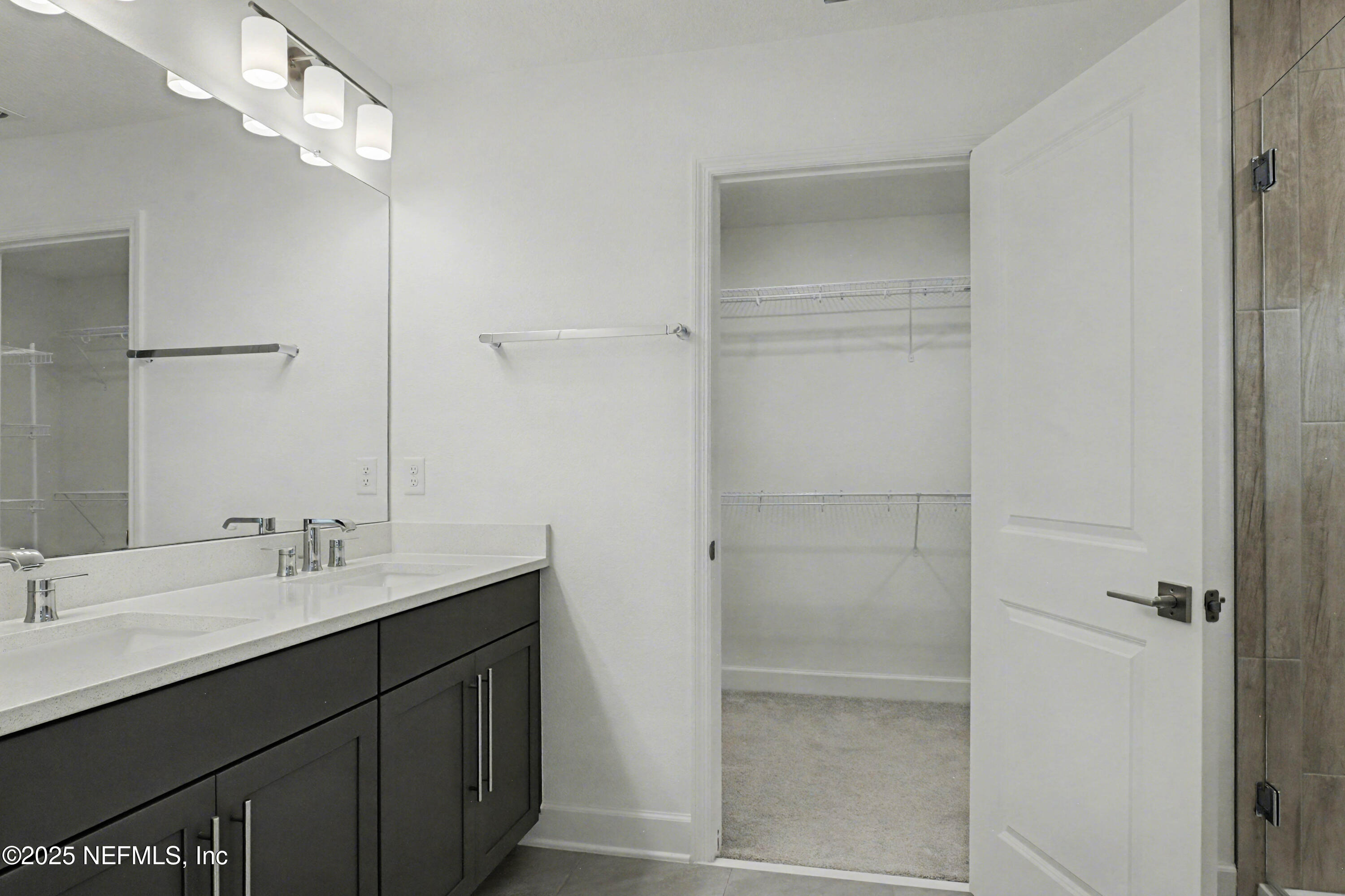 111 Windswept Way St. Augustine, FL 32092 - Photo 28 of 63 a bathroom with a double vanity sink a shower and a mirror