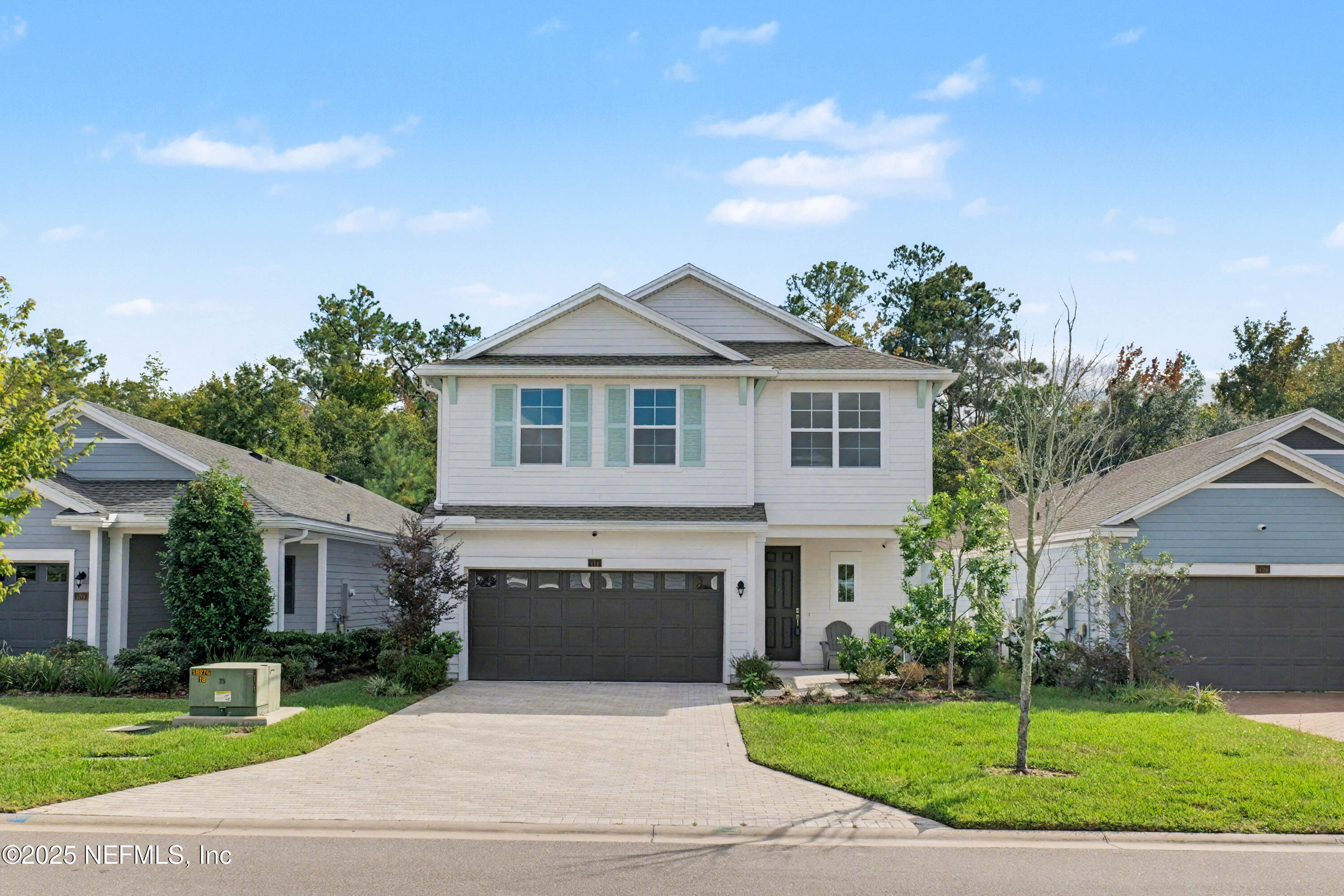 111 Windswept Way St. Augustine, FL 32092 - Photo 3 of 63 a front view of a house with a garden and yard