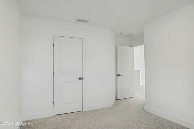 a bedroom with bed and a window