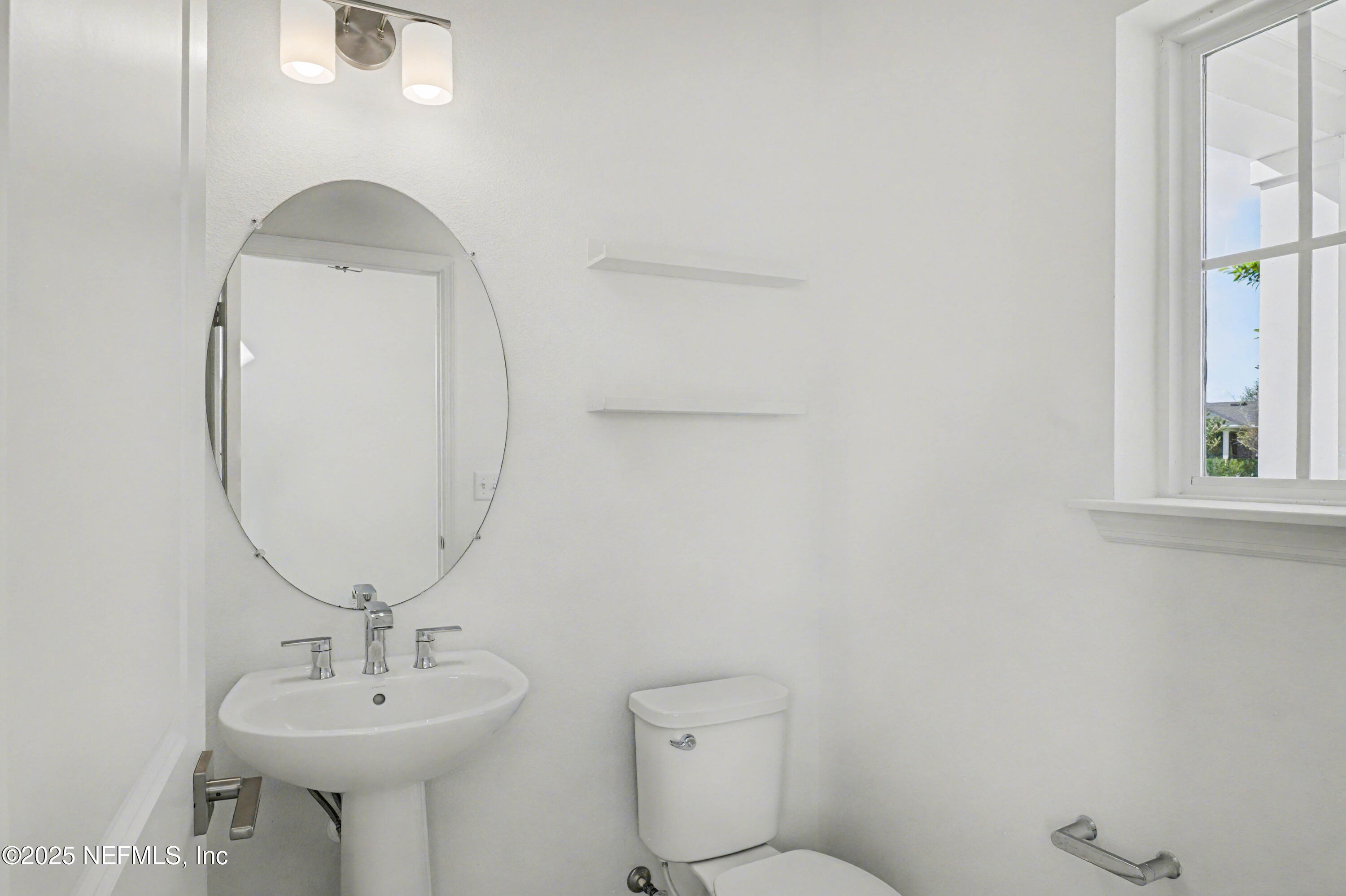 111 Windswept Way St. Augustine, FL 32092 - Photo 40 of 63 a bathroom with a sink a toilet and mirror